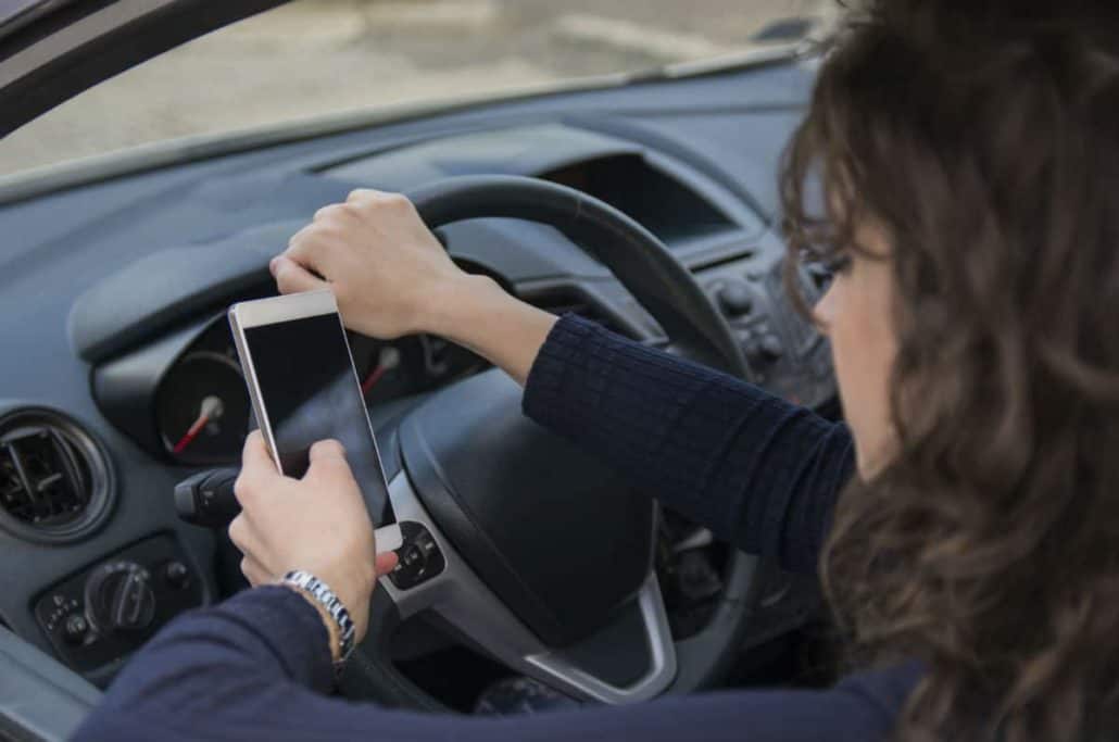 woman distracted by cell phone while driving